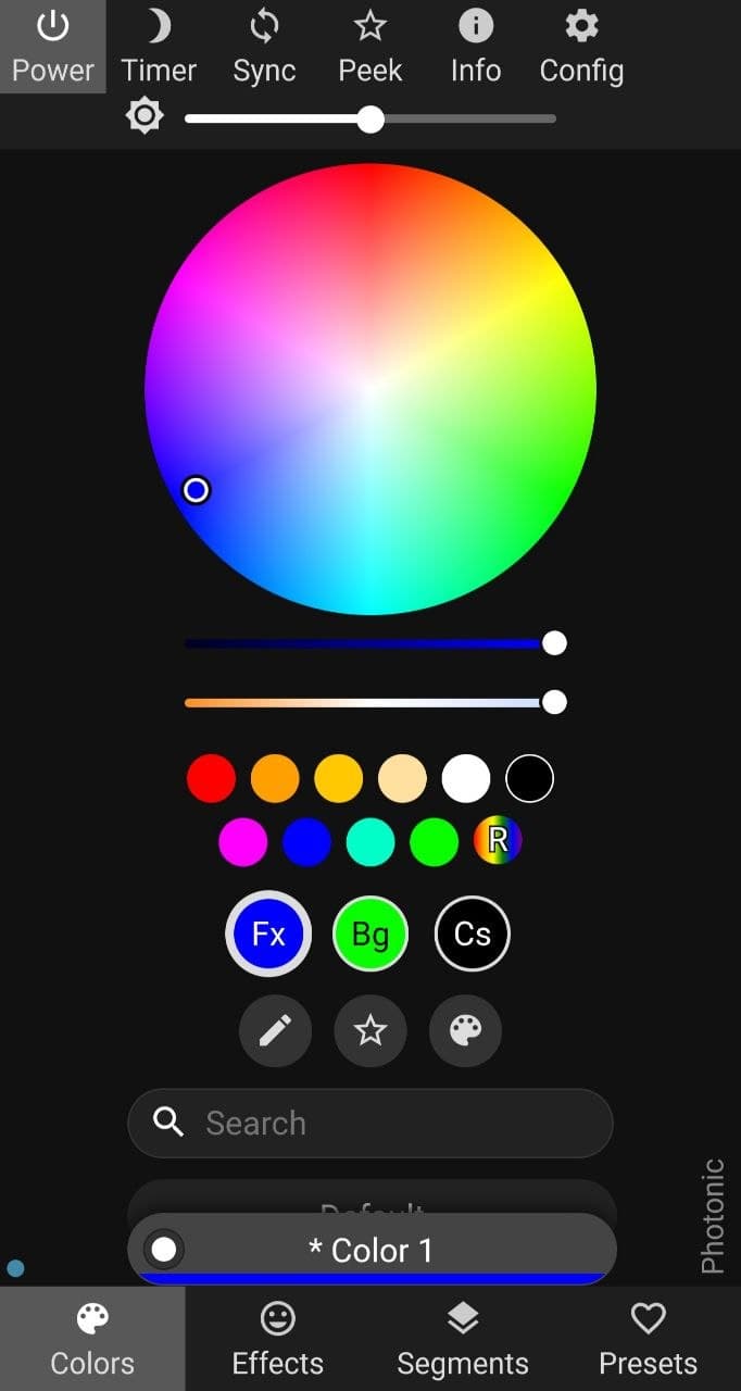 A screenshot of the software used to control the lights of the acrylic standees. It features a color wheel in the top center with predetermined colors beneath. Power, Timer, Sync, Peek, Info, and Config tabs are at the top of the page. Colors, Effects, Segments and Preset tabs are at the bottom of the page.